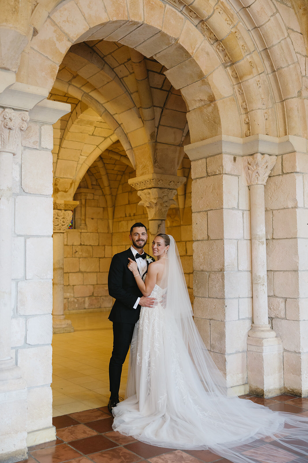Documentary wedding photograph of newlywed couple in historical stone venue | Sush Digital Media