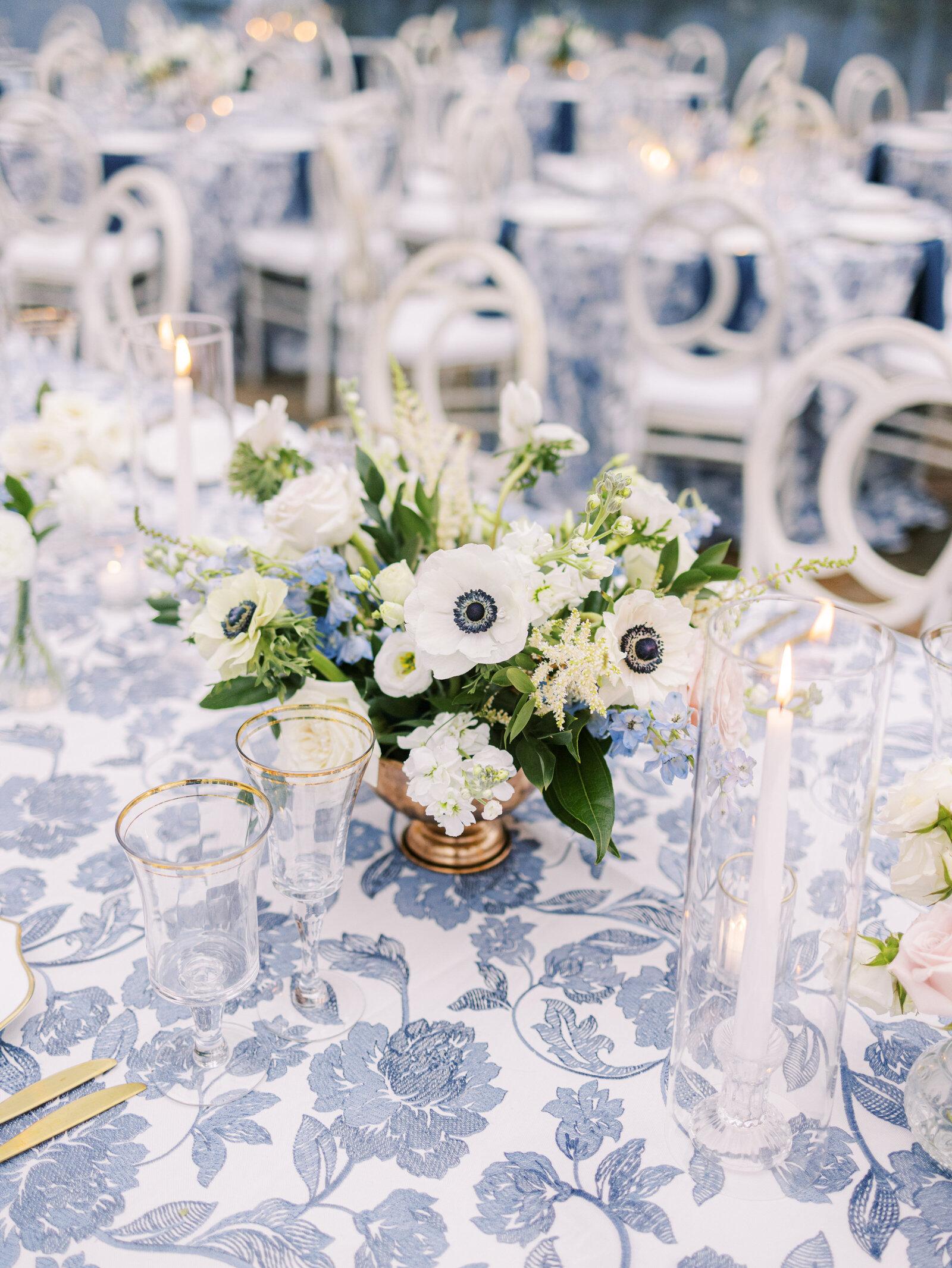 Blue, white, and gold wedding reception florals decoration at a wedding at Legare House in Charleston, South Carolina