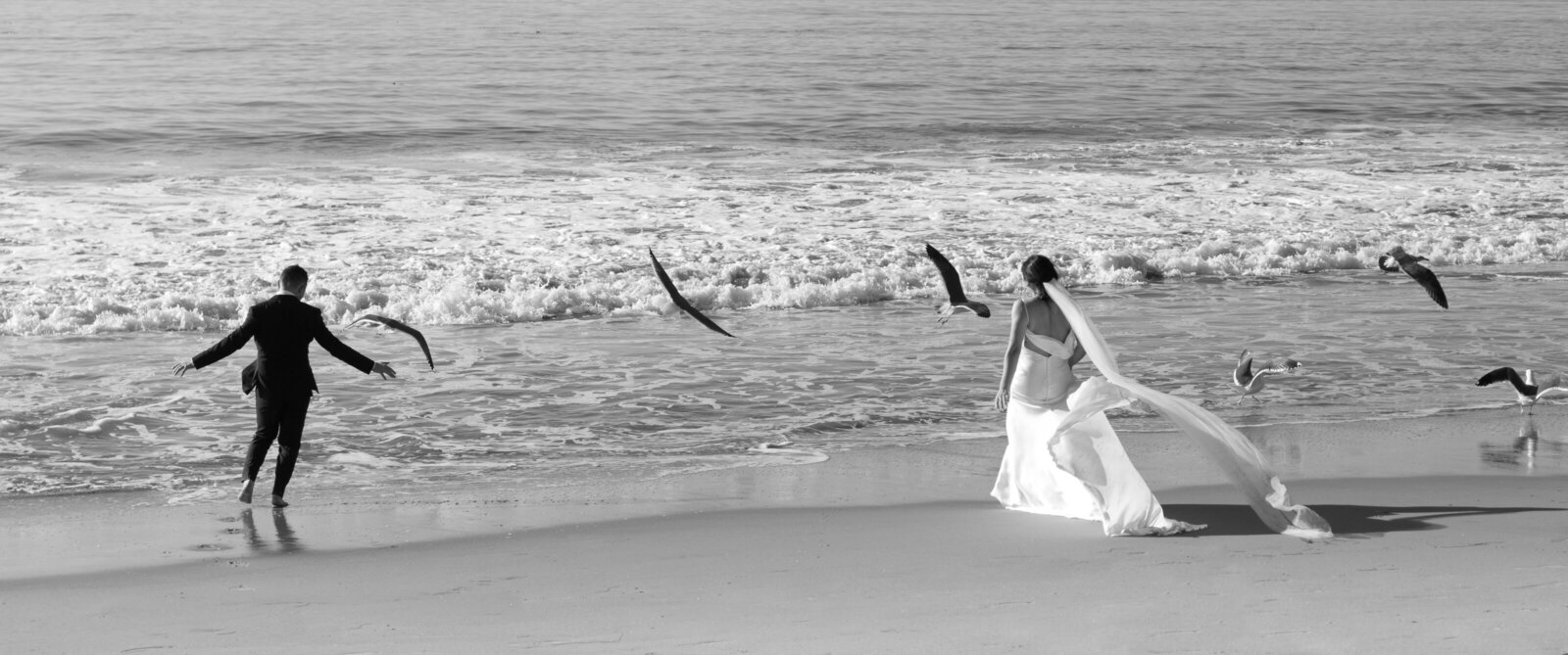 bride and groom running on the beach
