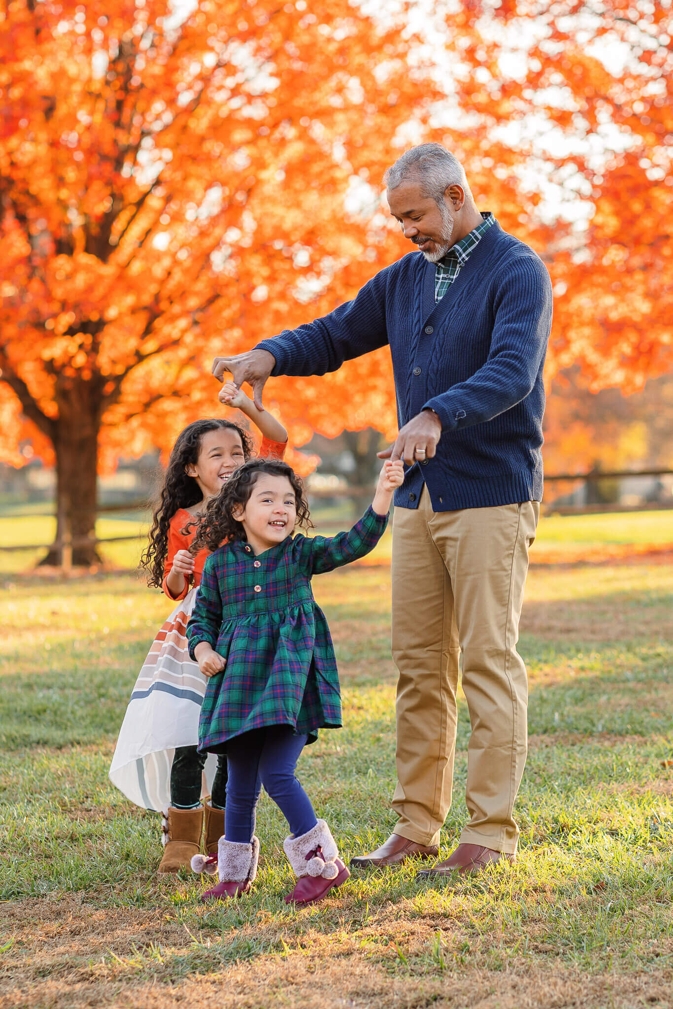 A dad twirling his two daughters