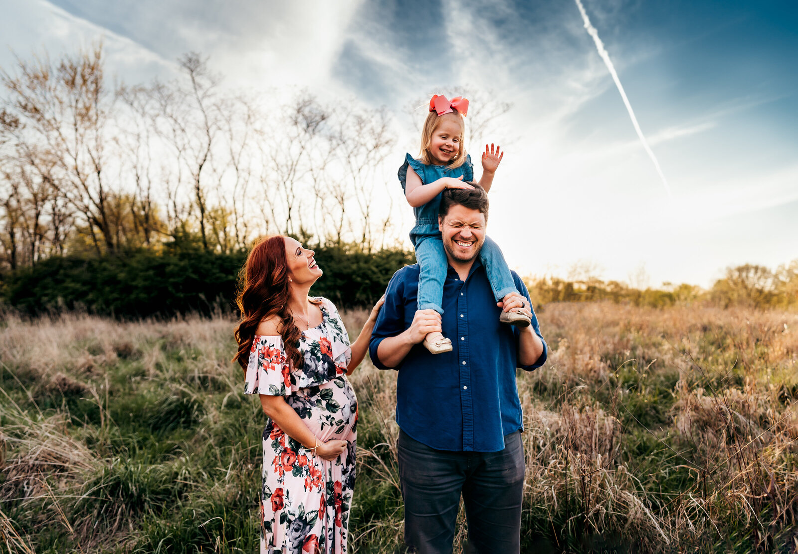 family laughing during st. louis maternity photo shoot