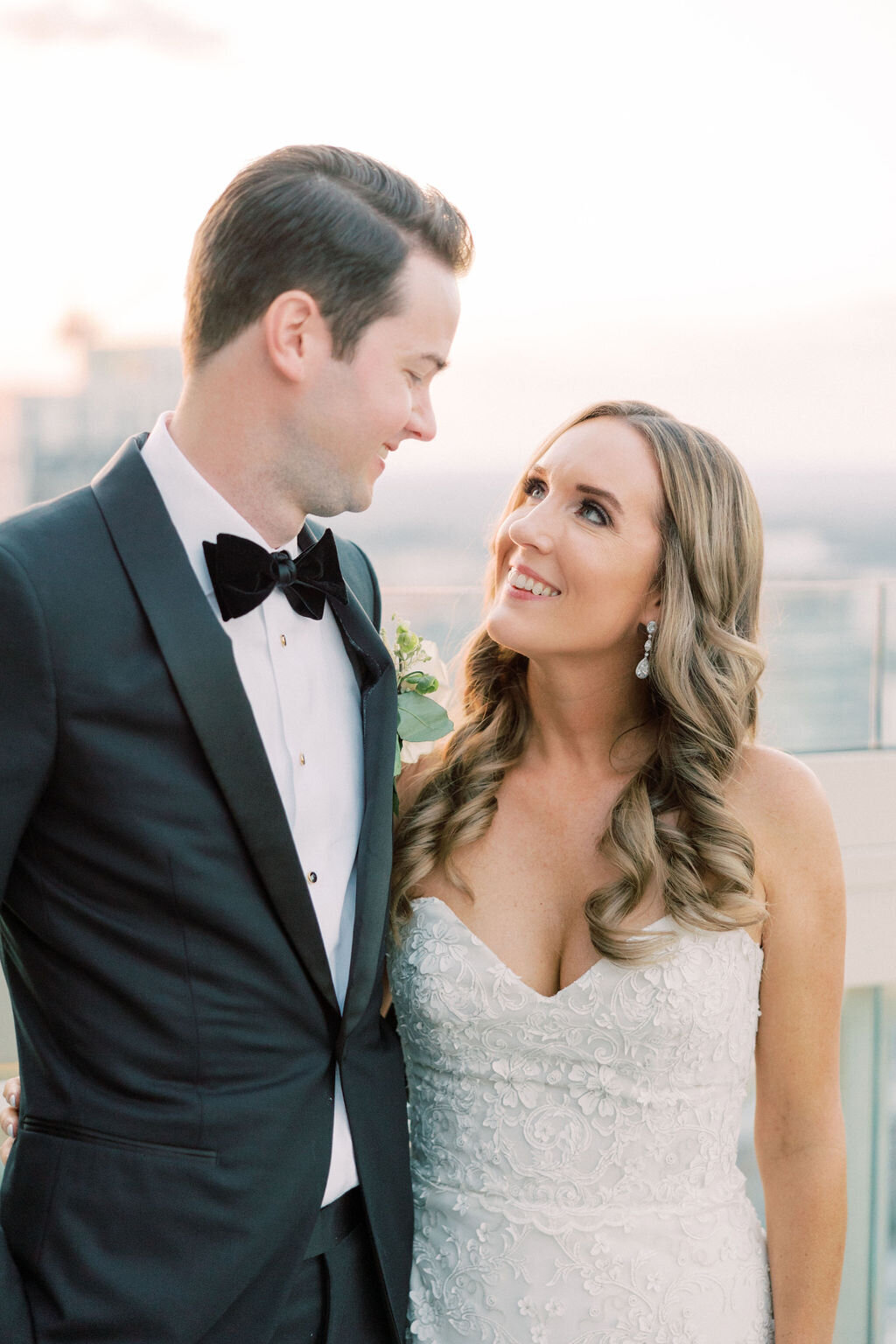 Bride looks up at groom with Atlanta skyline in background