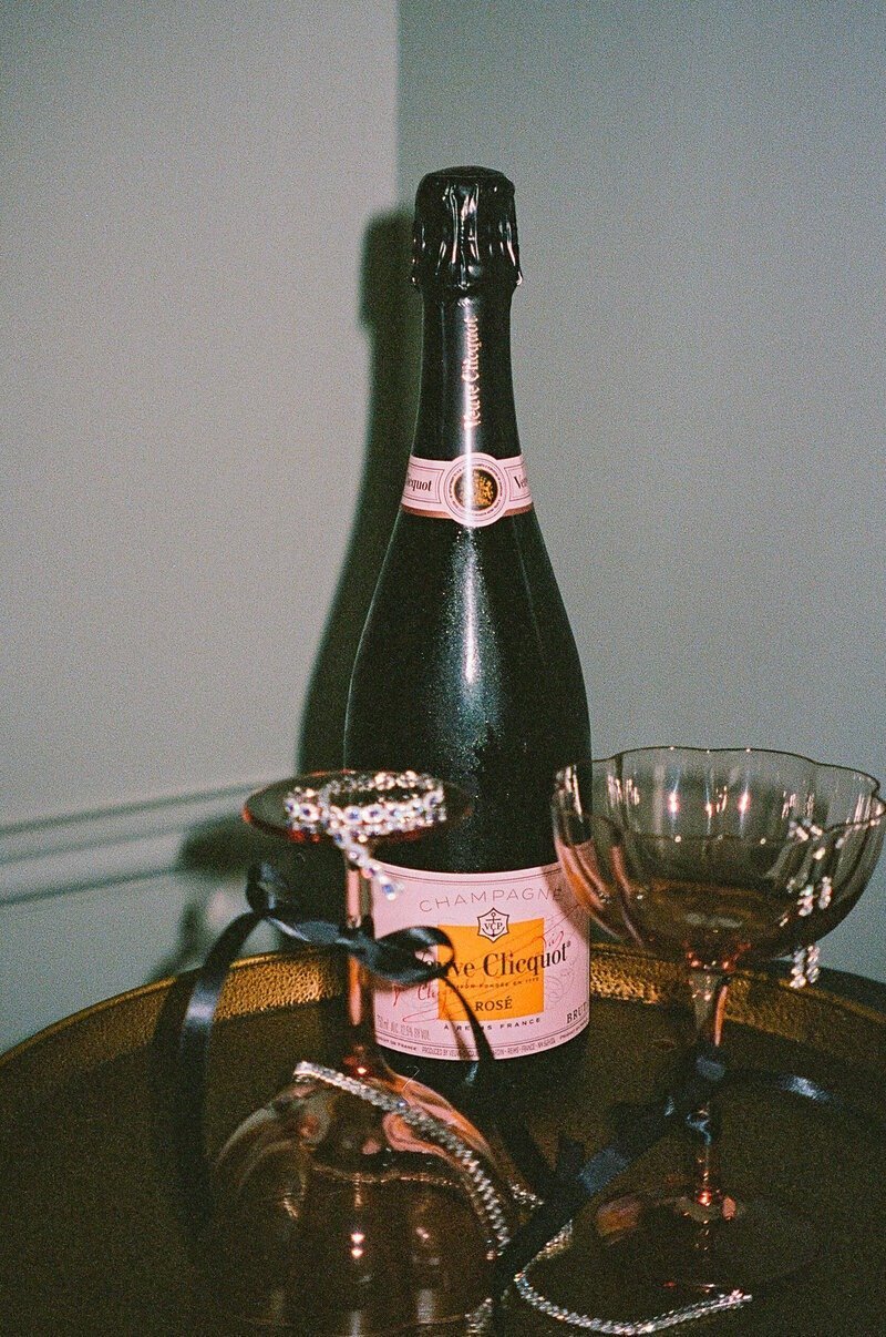 bottle of champagne with glasses taken by wedding photographers in fort myers