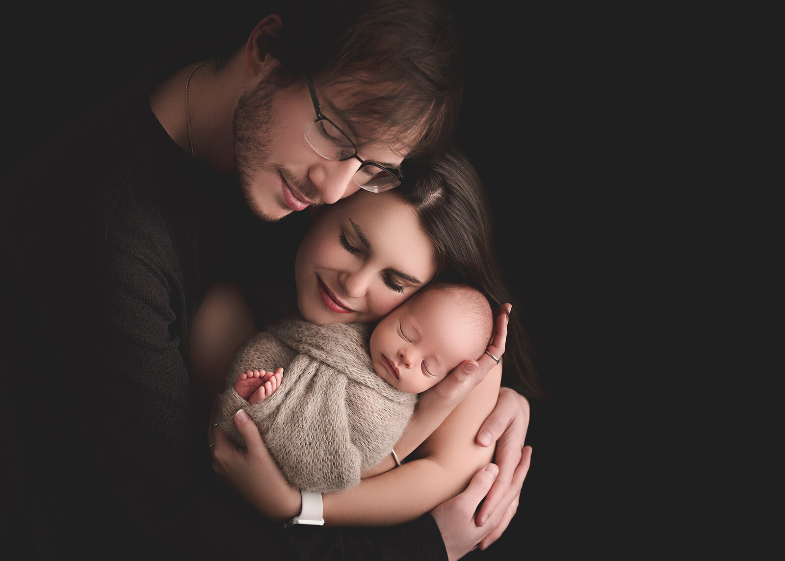 black and tan family portrait with baby in studio setting