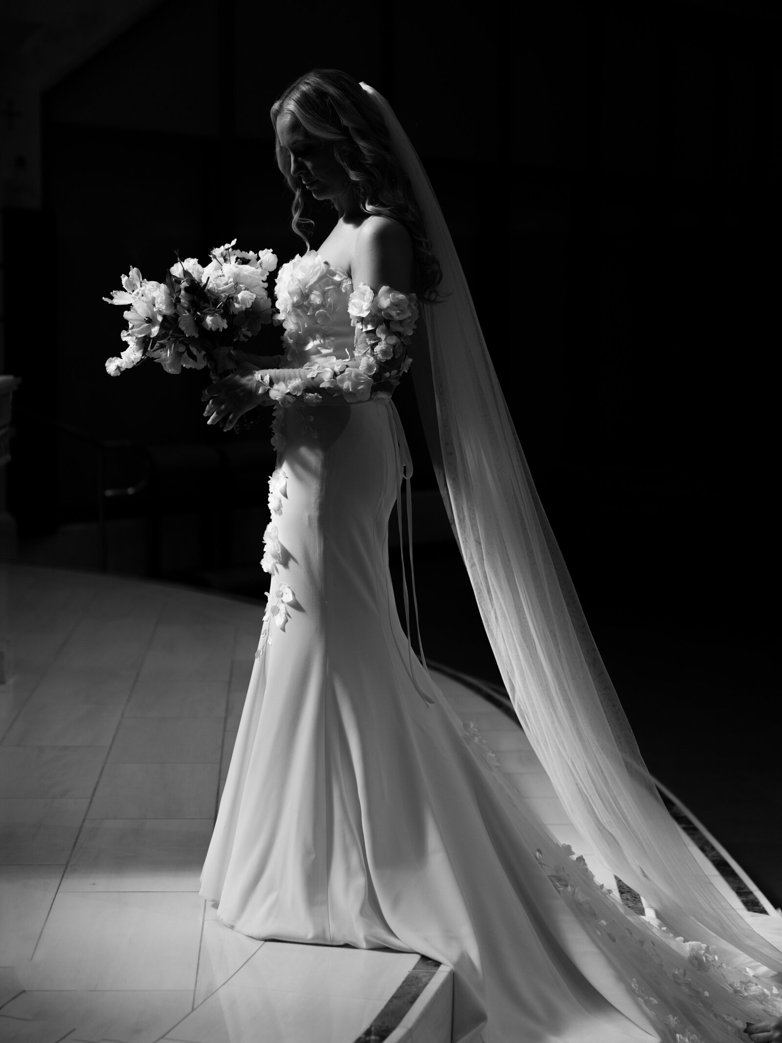 Bride looking down at florals at Church wedding in Southern California