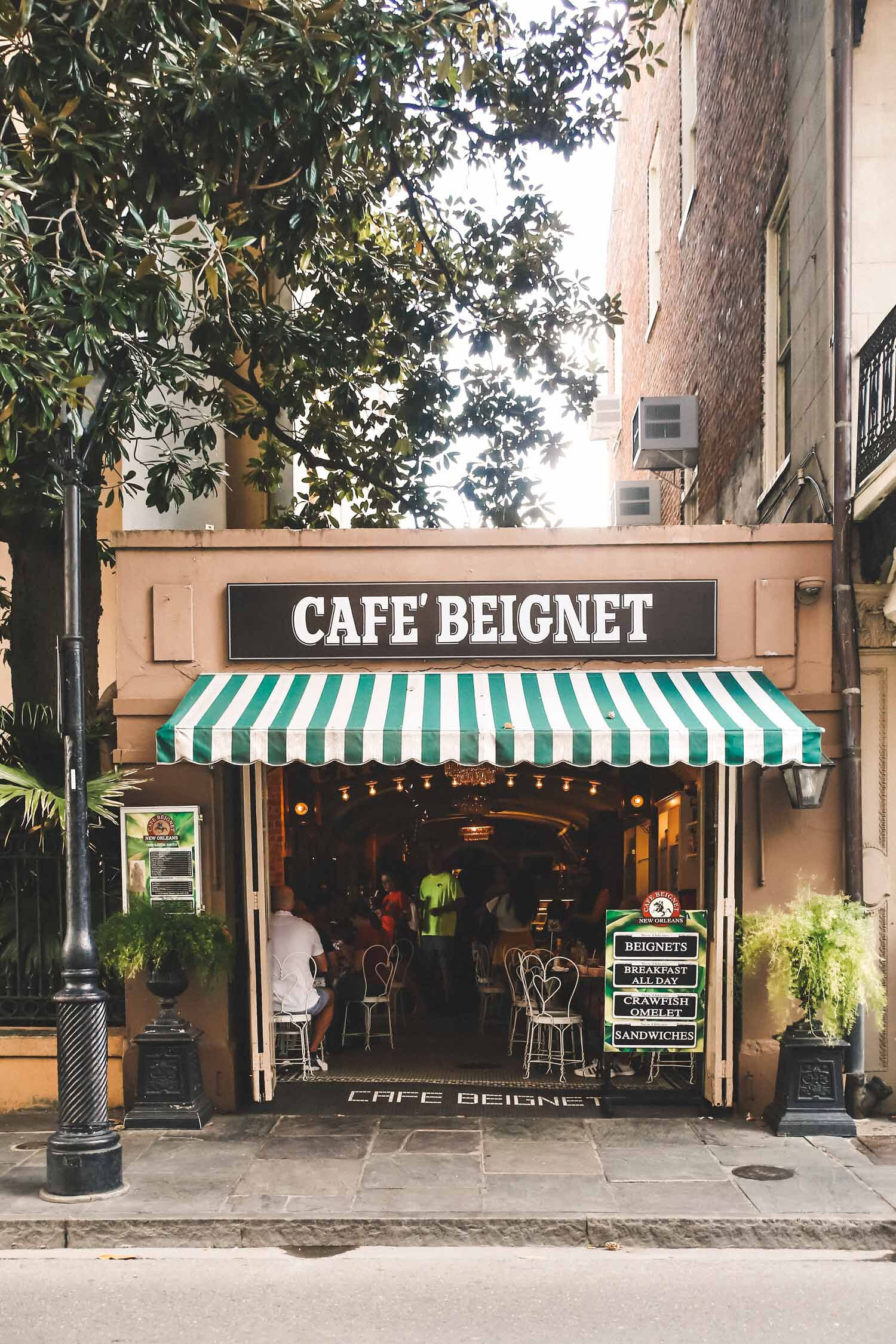 Chelsea Loren Tourism Branding Photographer in New Orleans at Cafe Beignet Cute striped cafe in French Quarter