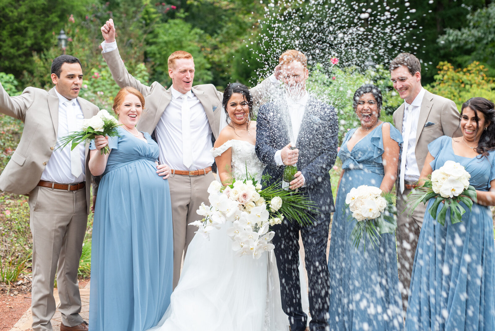 botanic garden wedding bride and groom popping champagne with wedding party