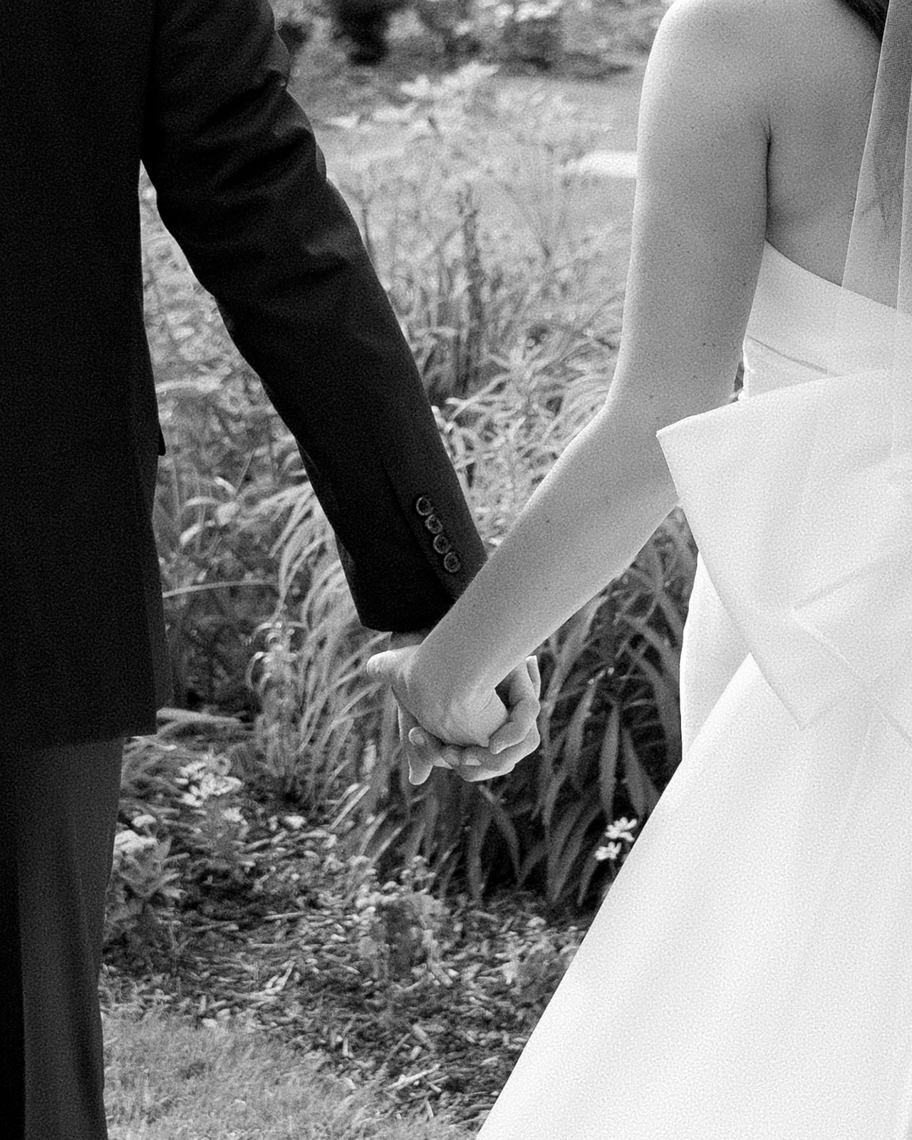 Bride and groom holding their hands walking outdoors | Megan Smith Photography