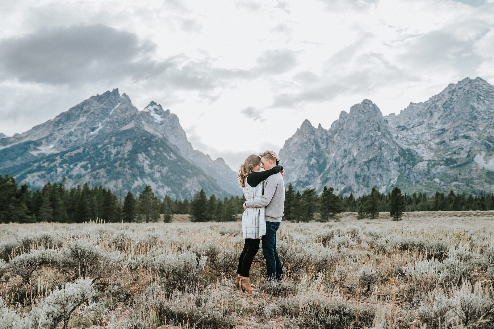 Lake Tahoe wedding photographer captures couple embracing during mountain engagements