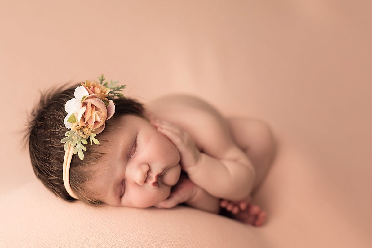 newborn-girl-dark-hair-on-pink-decatur1