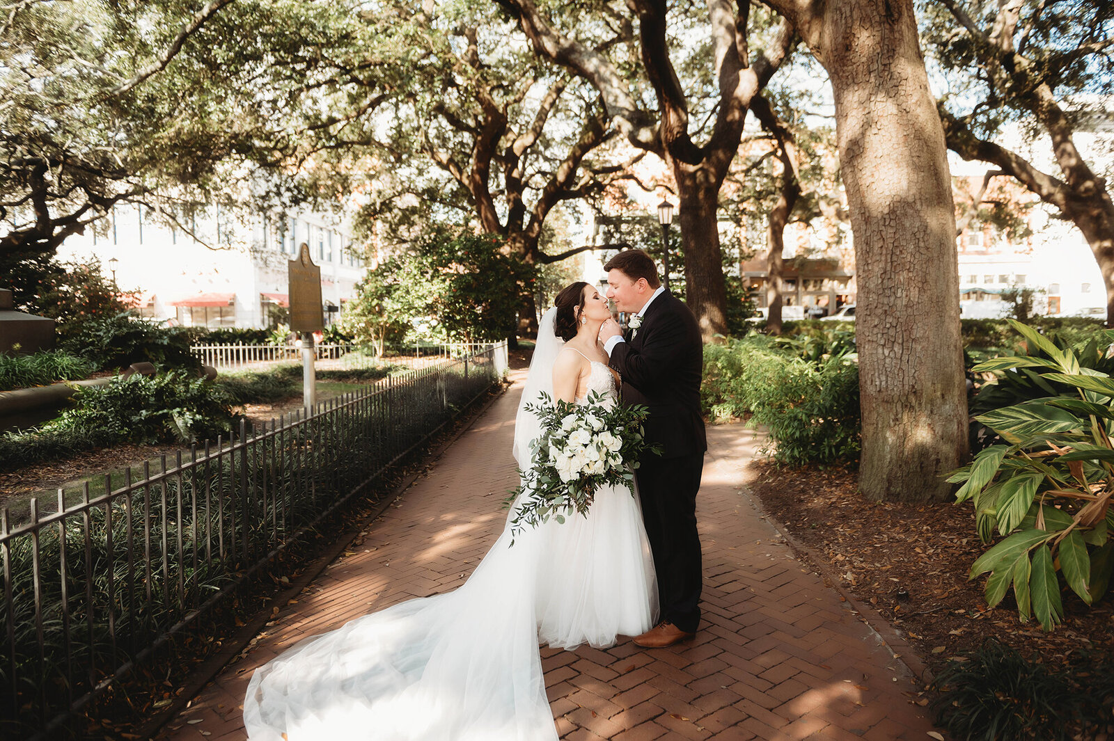 Newlyweds kiss during portraits during their Micro-Wedding in Savannah, Ga.