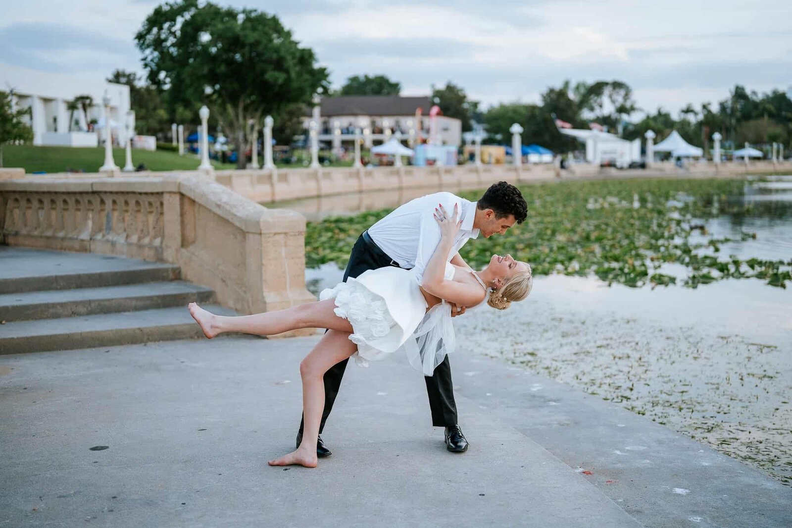 groom dipping bride portrait - Lakeland Fl wedding venue magnolia building at Lake Mirror