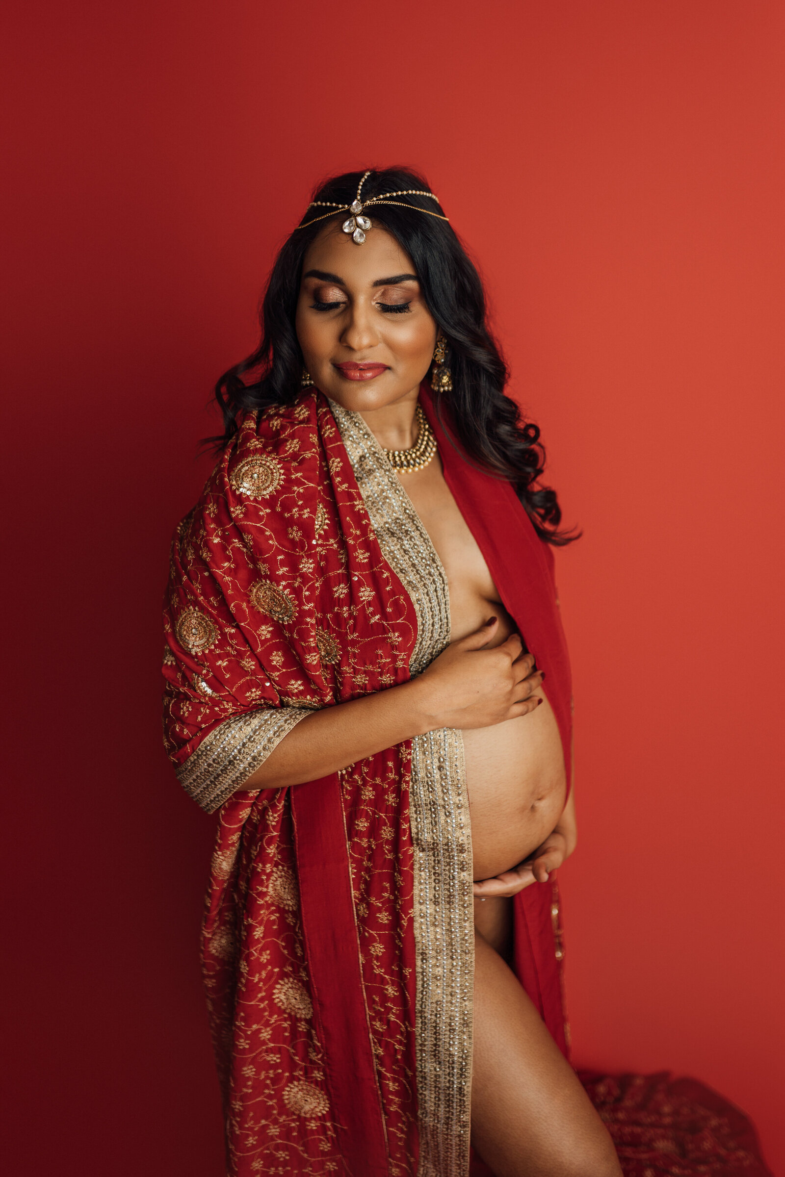 mom wears traditional indian dress for studio maternity session in Tampa