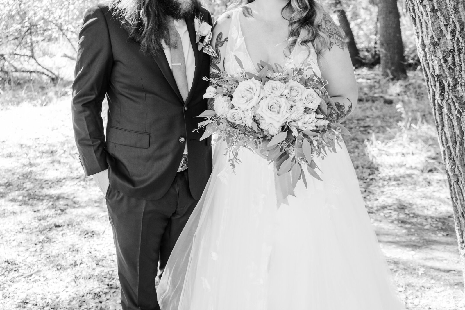 Tattoo bride and groom embrace on their colorful wedding day in Santa Cruz, California.