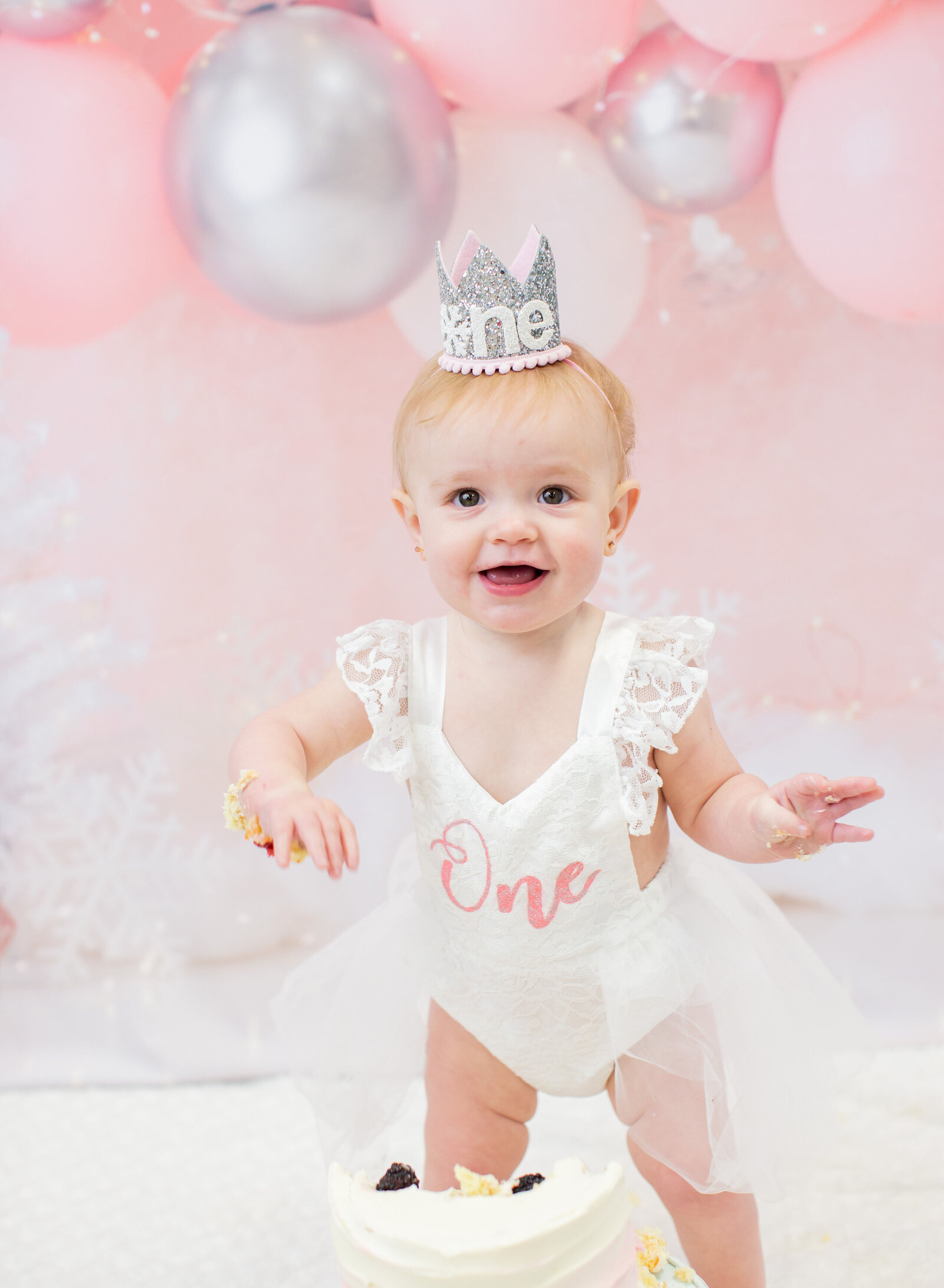 first birthday girl with cake