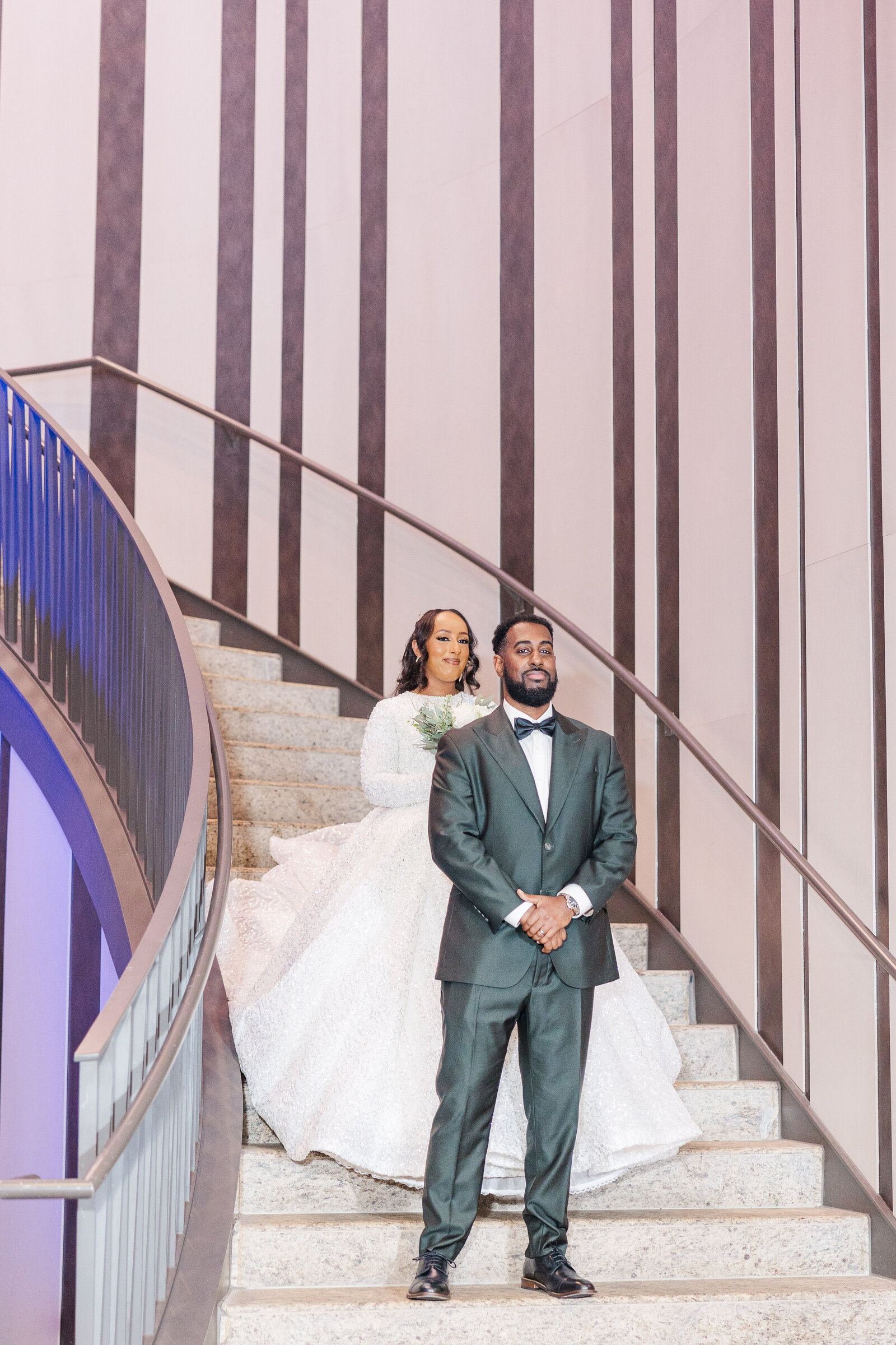 Bride walking down the stairs for first look 
