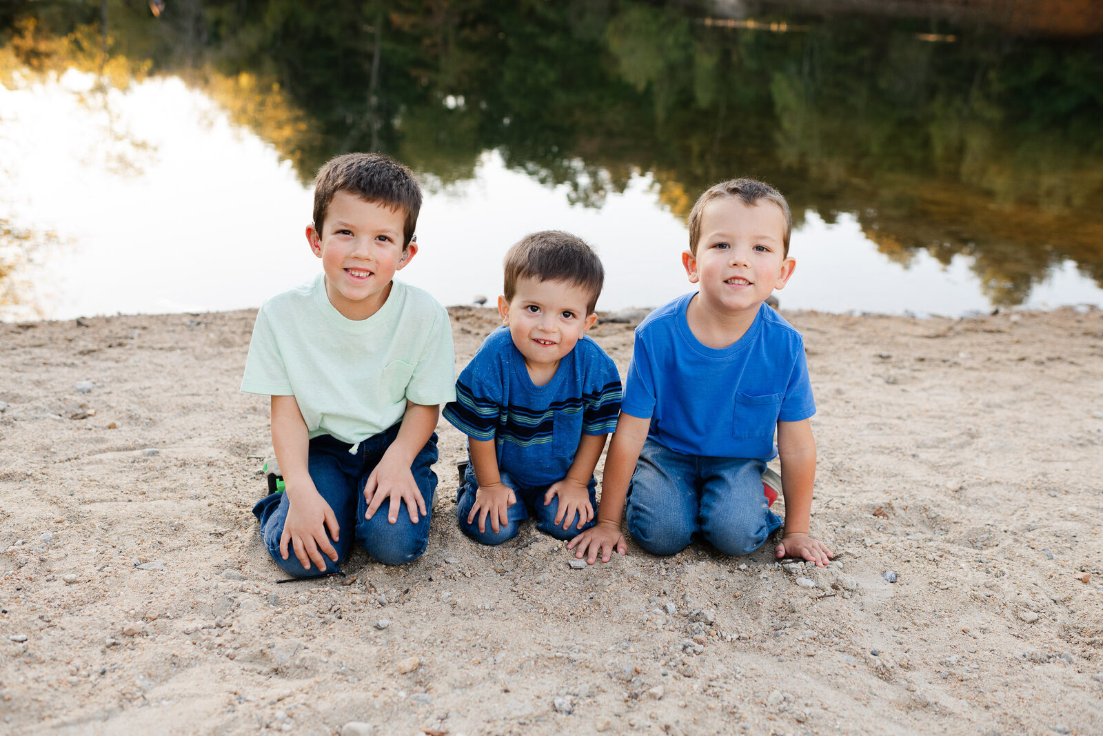brothers kneeling on sand
