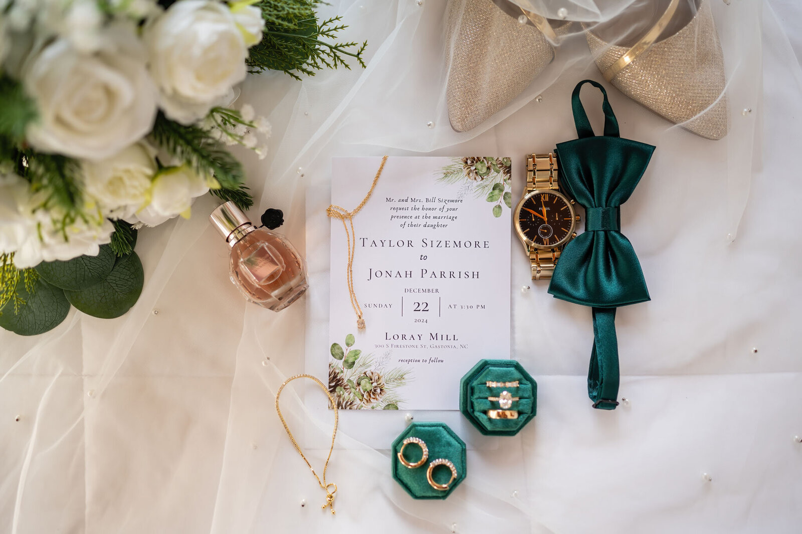 Flat lay of wedding details with invitation and accessories