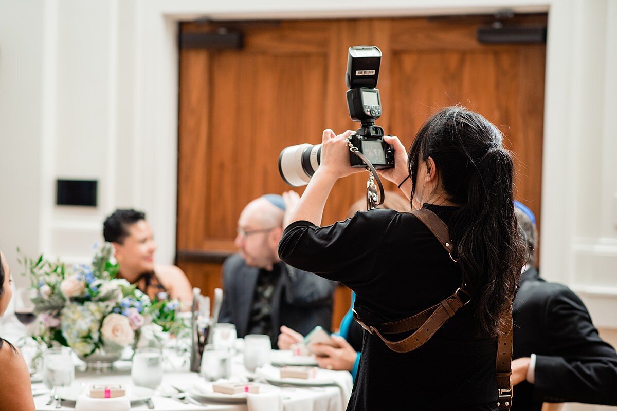 Behind the scenes photo of photographer taking photos at a wedding