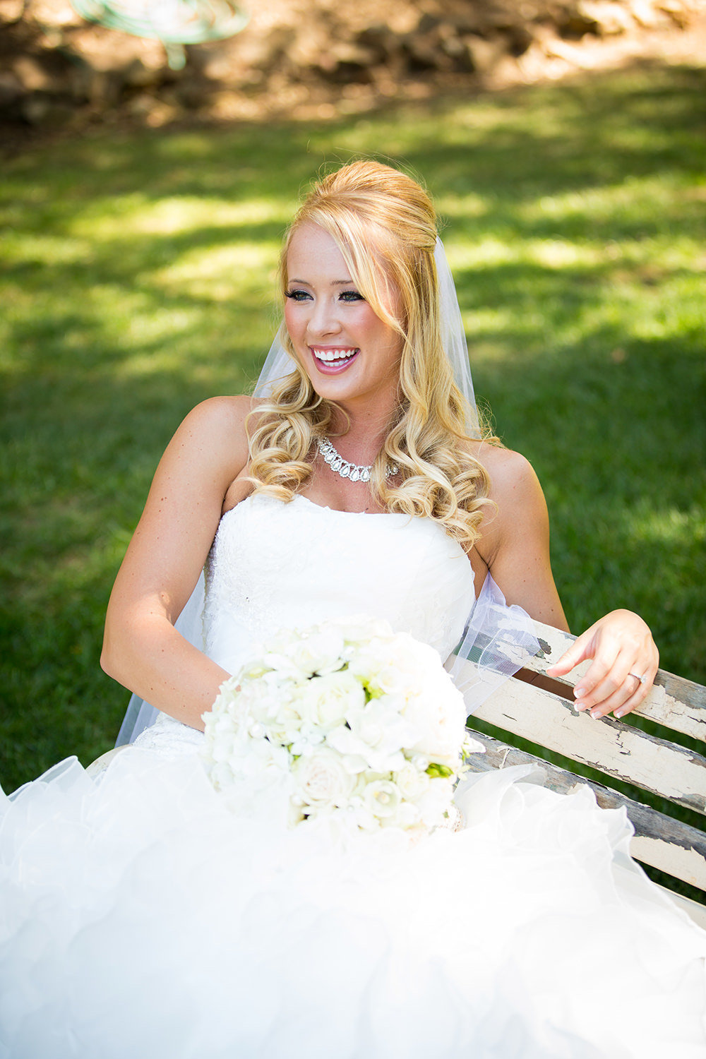 bride laughing on bench at los willows