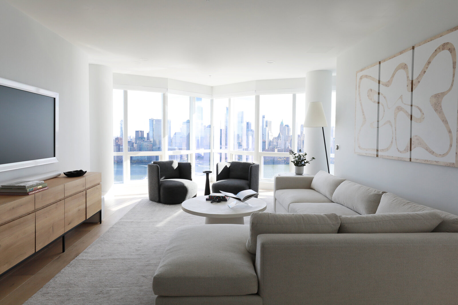 LUXE MODERN LIVING ROOM WITH SECTIONAL SWIVELS AND ART