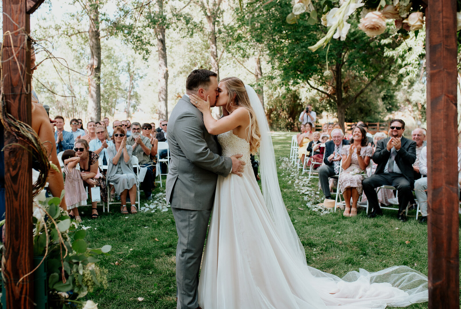 Beautiful portrait of bride and groom having their fist kiss.