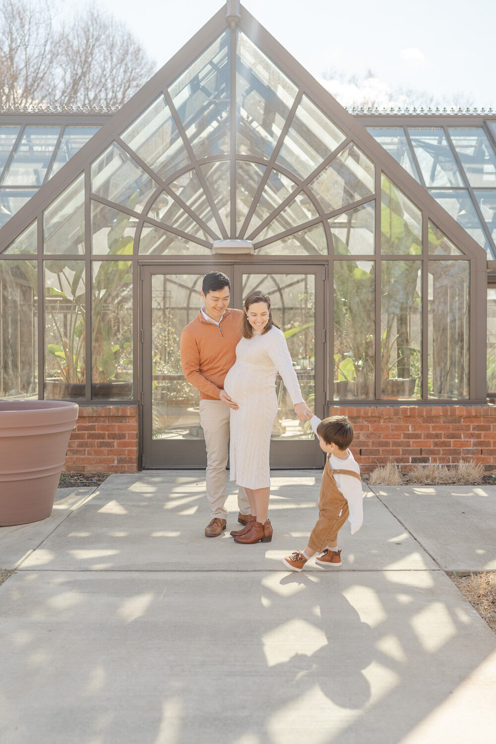 big brother pulling mom during maternity session in Reston, Virginia