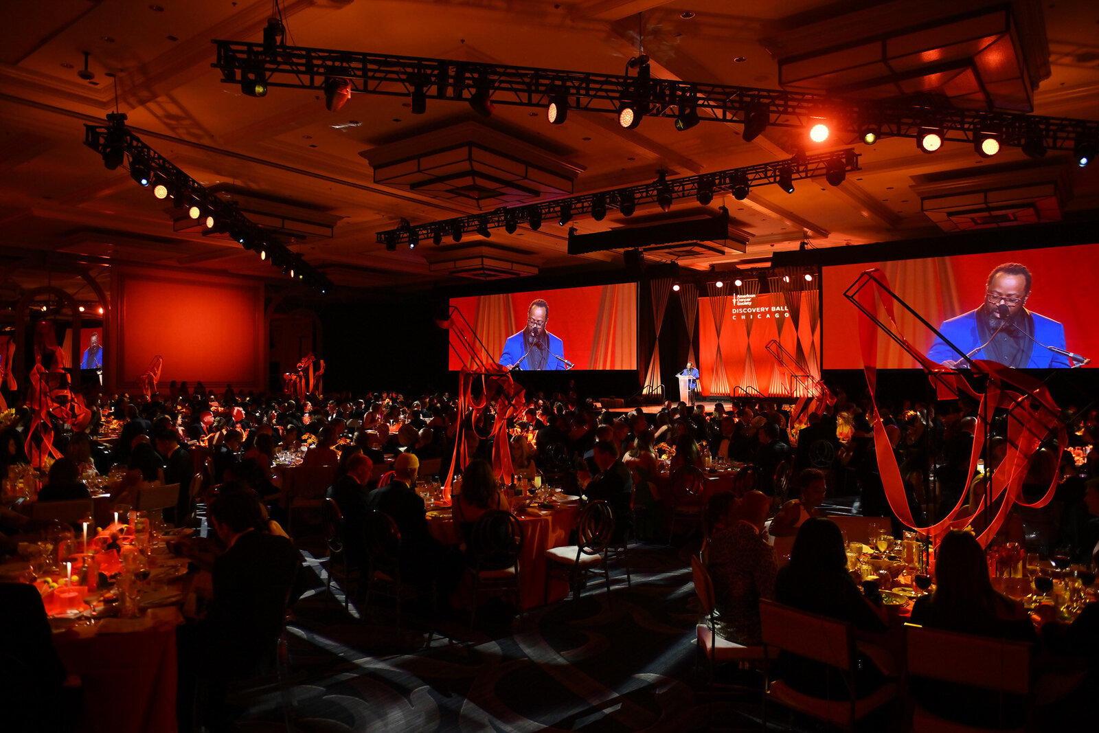 Corporate event stage with dramatic uplighting and Chicago DJ setup