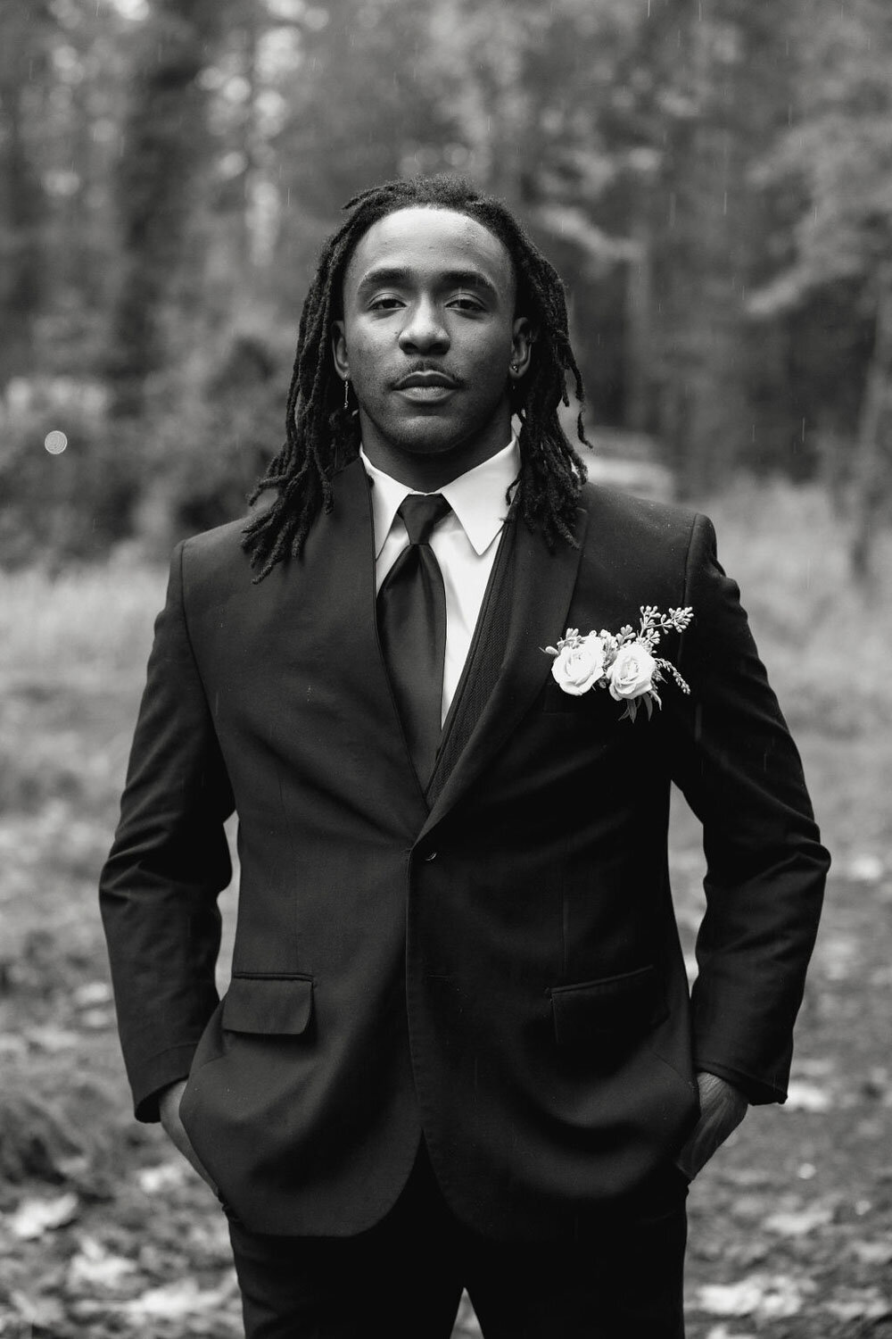 groom in suit standing outdoors