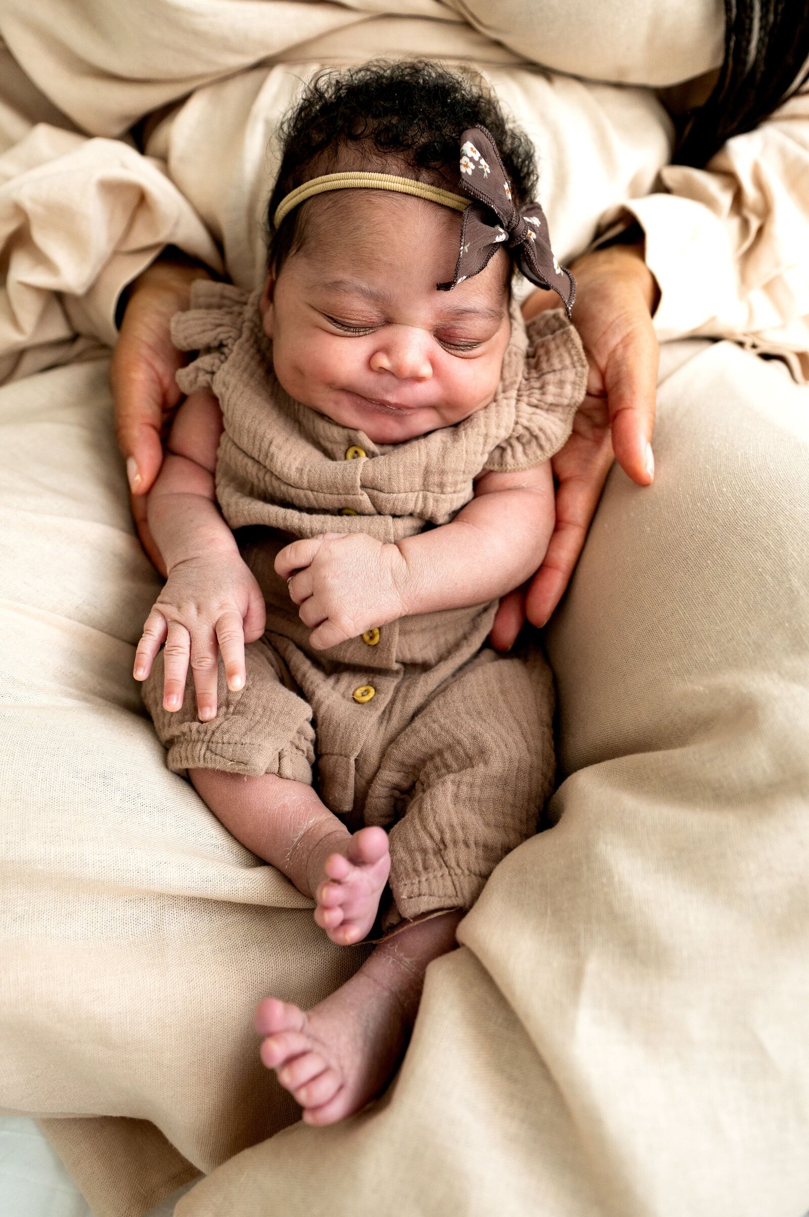 newborn baby in moms  lap