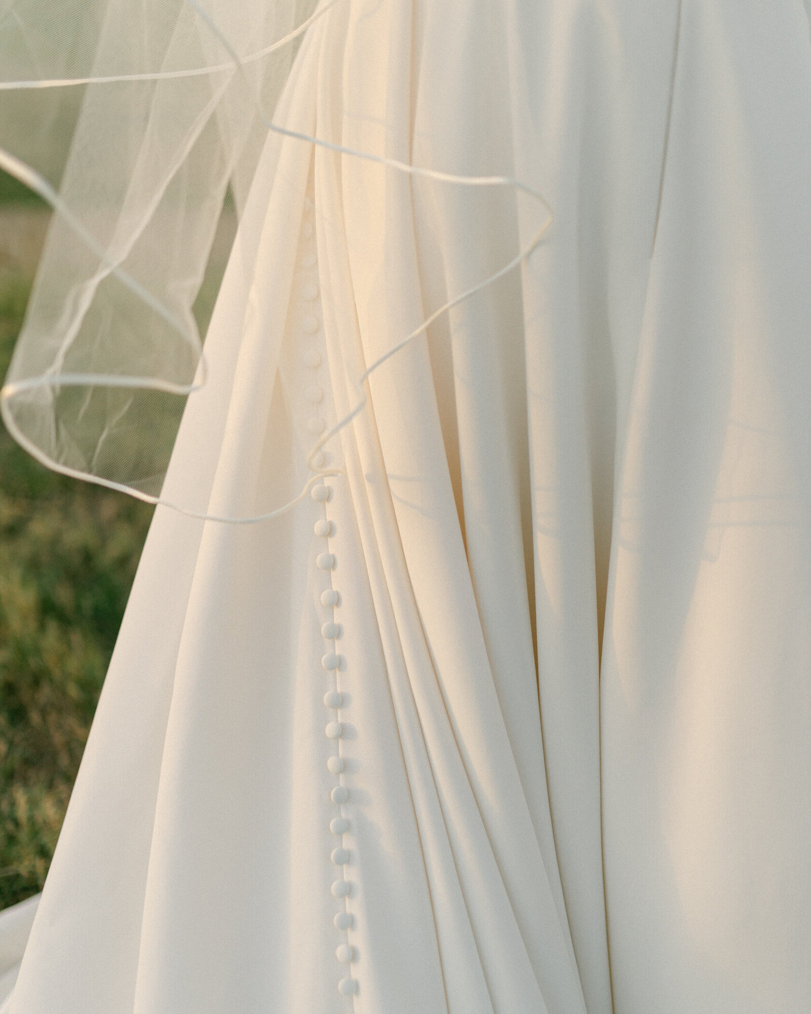 Button detail on Fort Worth Bridal gown and edge of bridal veil.