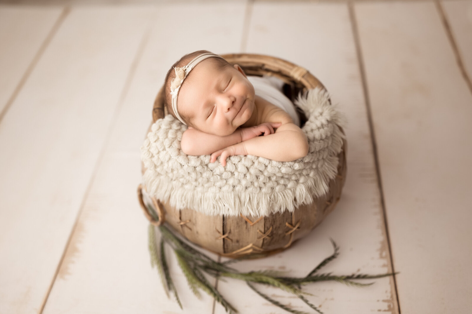 Newborn baby girl in a basket in studio near Birmingham