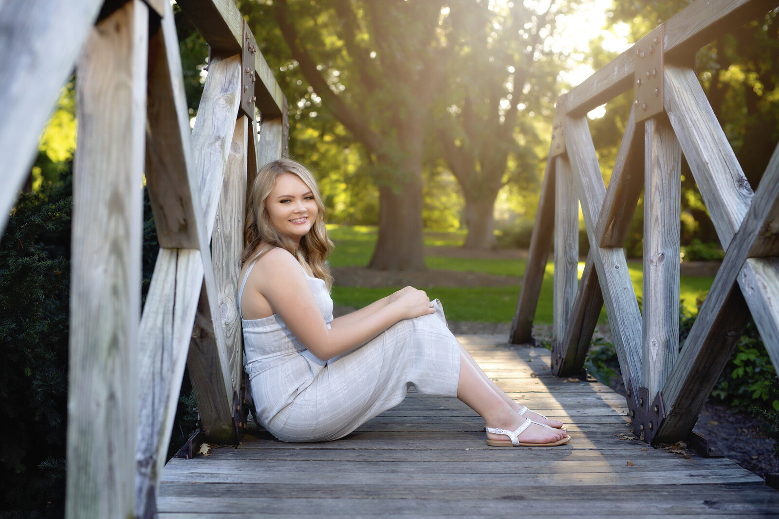 Schuyler rests against the side of a bridge during a senior photo shoot
