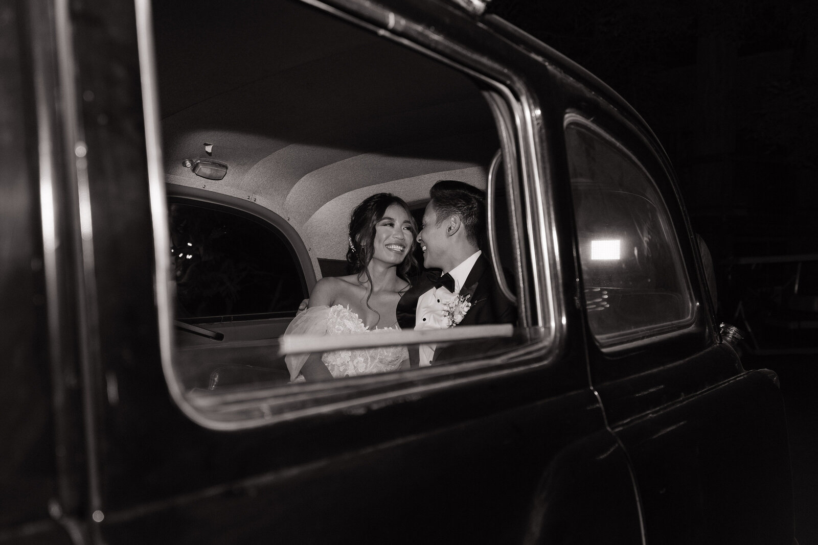 Couple admire each other in classic car by Washington adventure elopement photographer