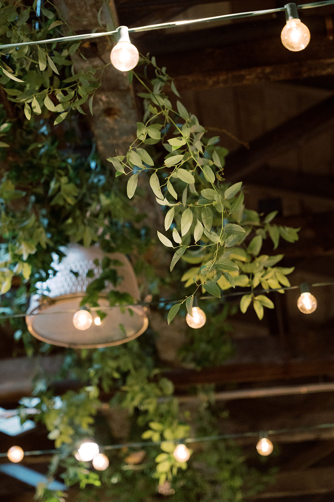 Smilax greenery and string lights in the ceiling at the Washington mill dye house.