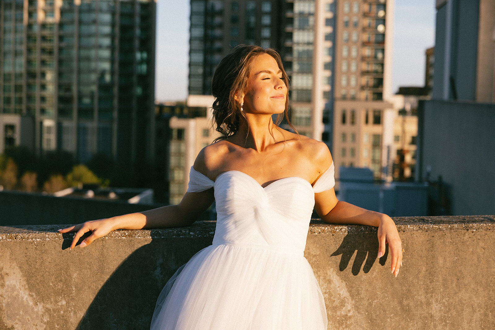 Bride basks in the sunlight on the eve of her wedding on a building in downtown Nashville, TN.