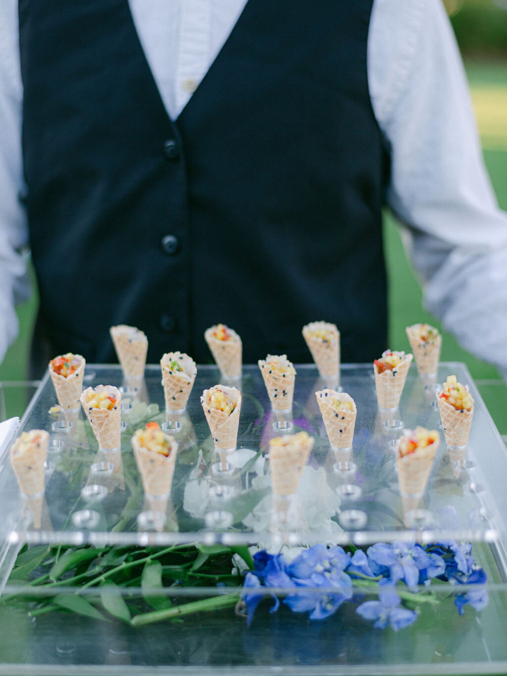 waiter holding tray of small cone appetizers at Alys beach wedding reception