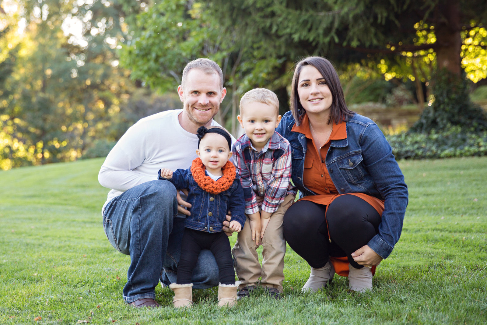 family with 2 young children family fall session wearing orange