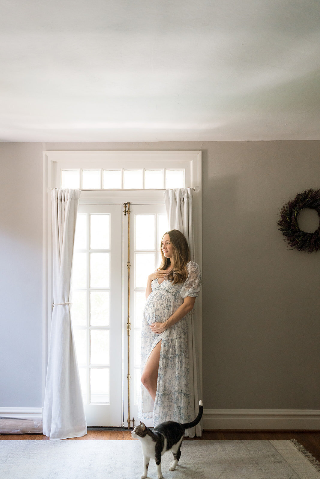 maternity mom standing near a door