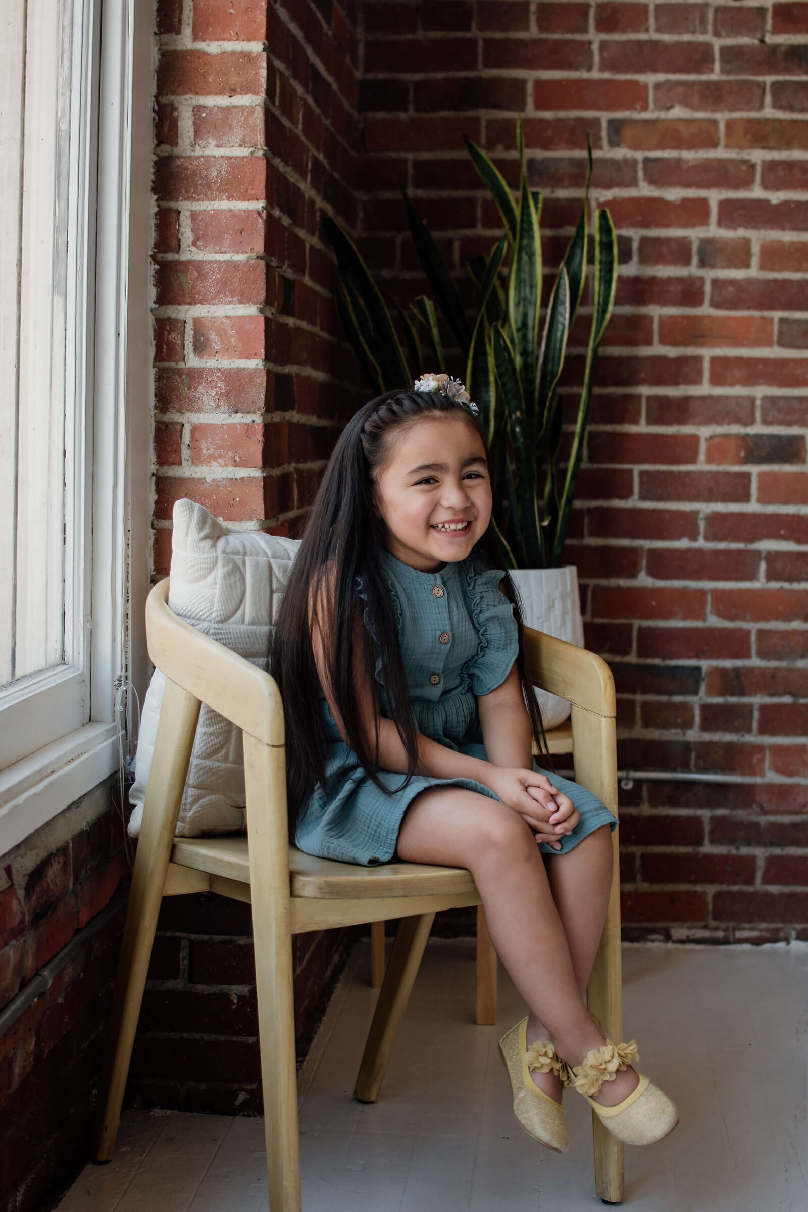 Little girl sitting in chair.