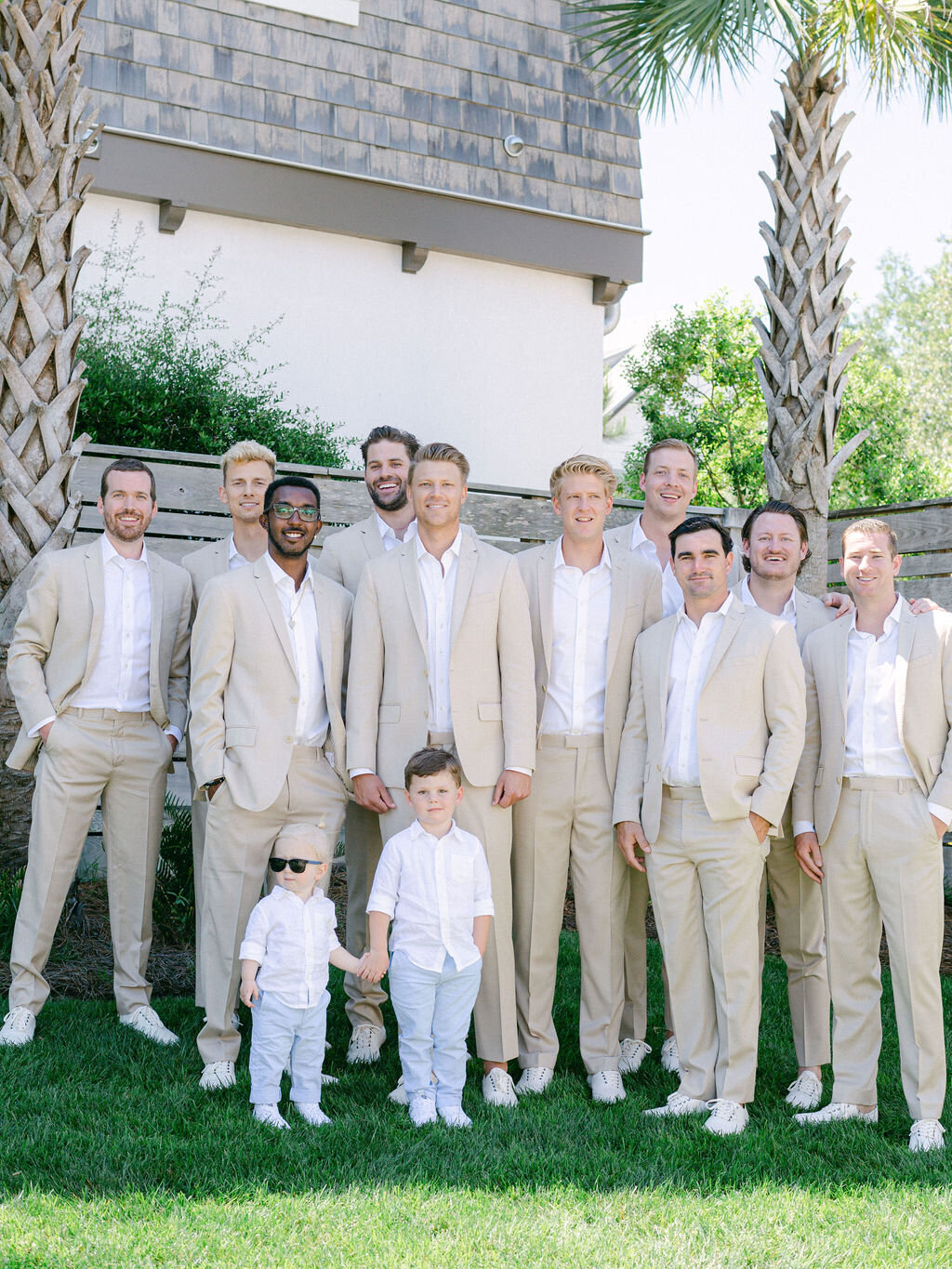 Groom with groomsmen in beige suits and white shirts  at destination wedding Florida