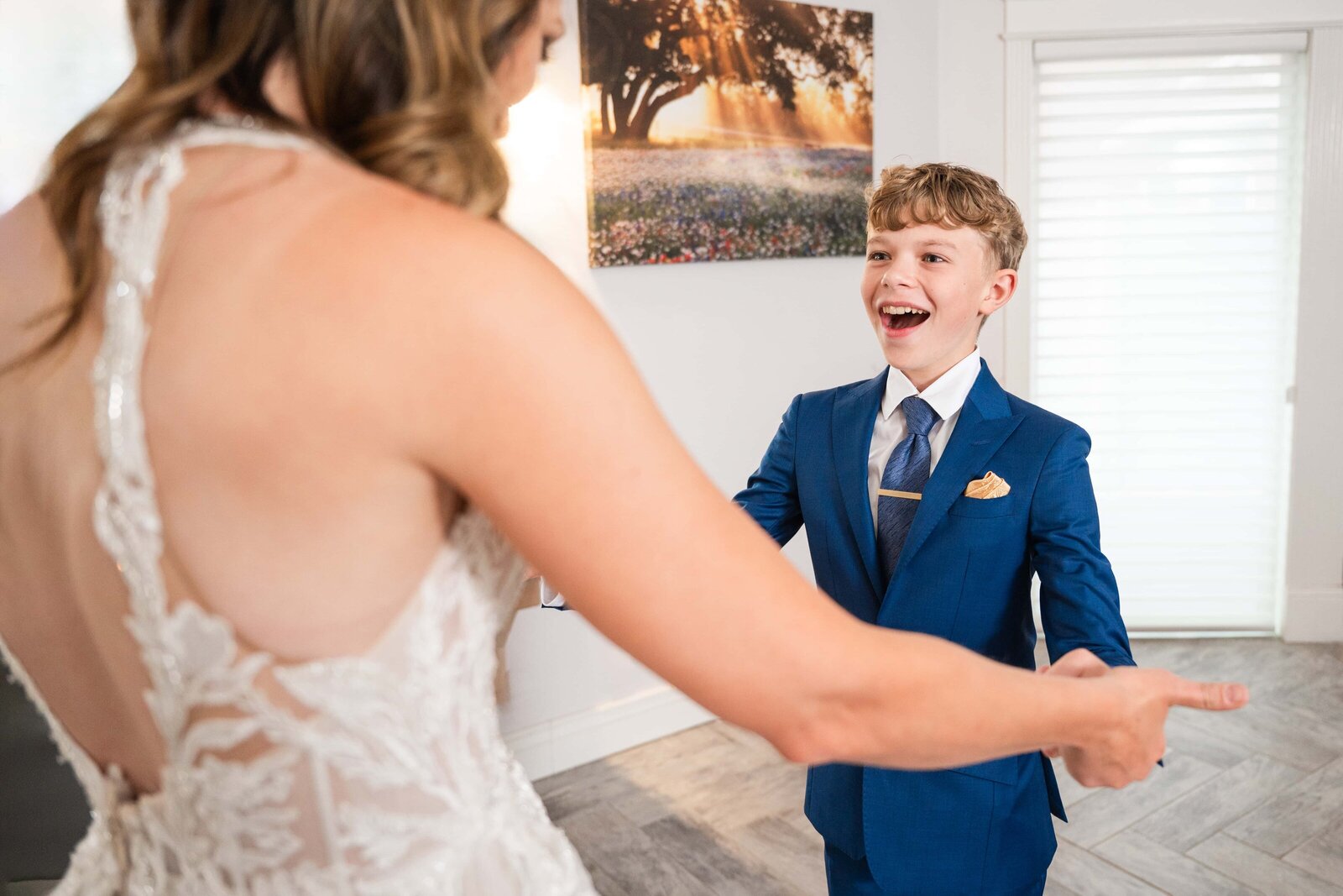 Son sees his mom in her wedding dress for the first time.