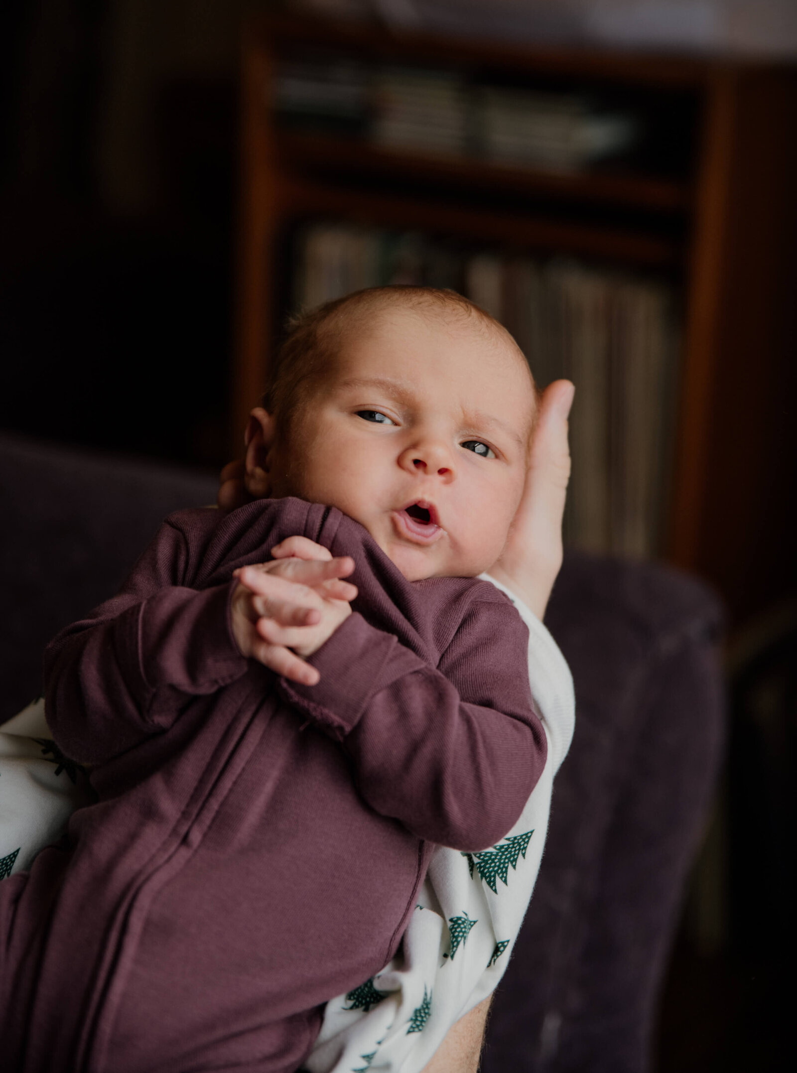 Baby girl being held.