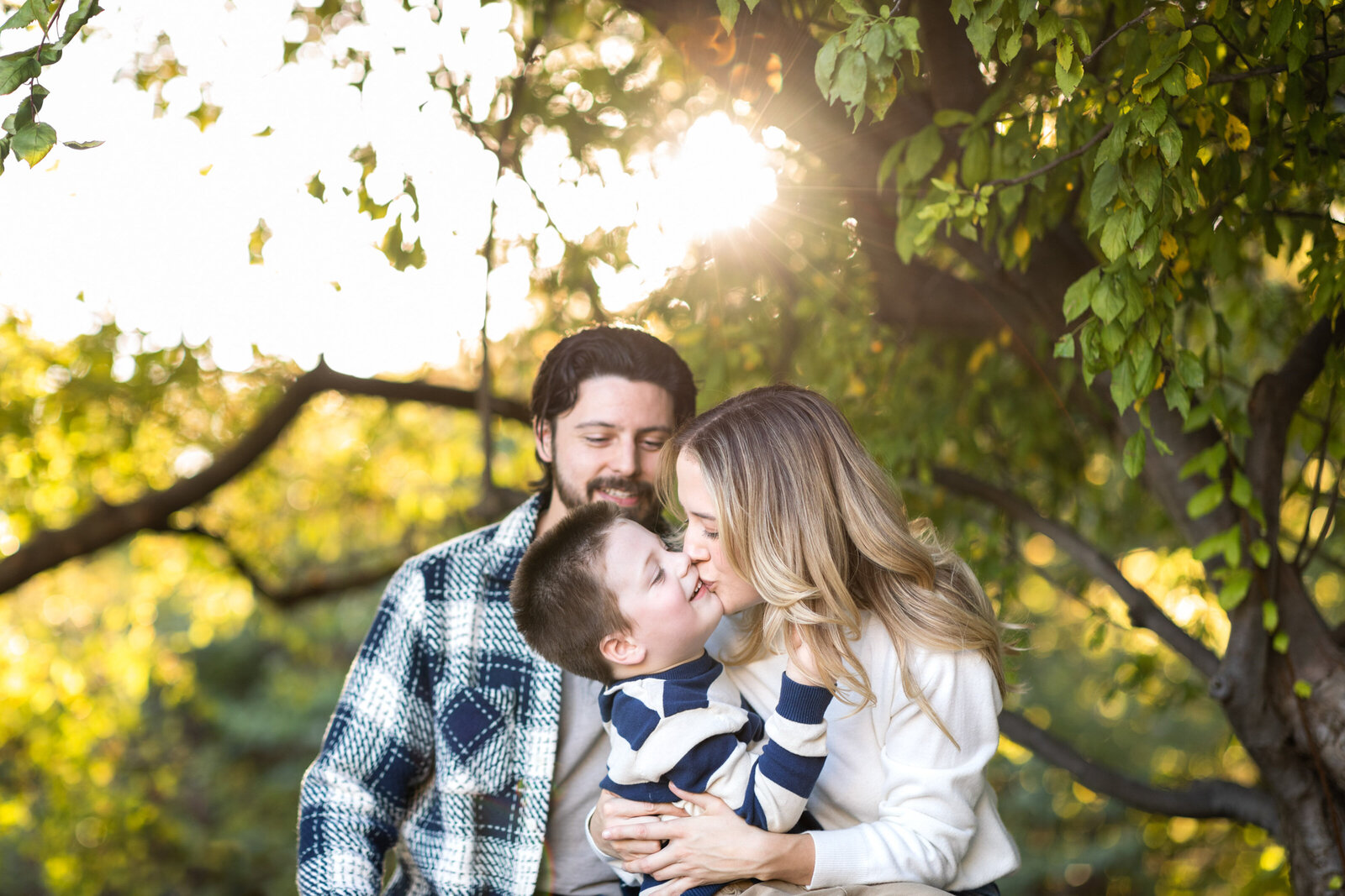 Kansas_City_Family_Photographer_Nelson_Atkins_Museum_of_Art_golden_hour_with_trees_mother_kissing_son-31