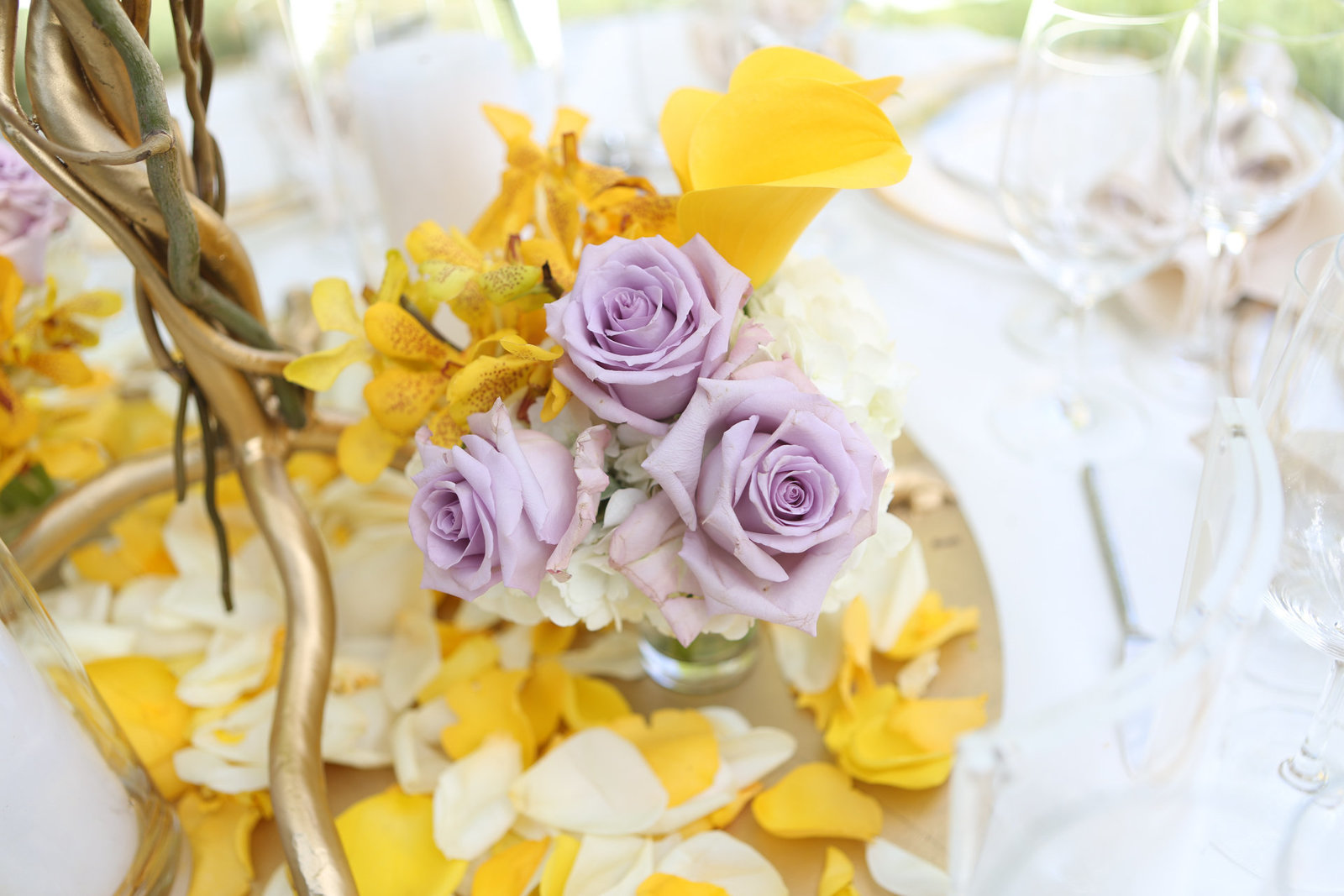 Stunning yellow and purple flowers decorate a table at a local wedding