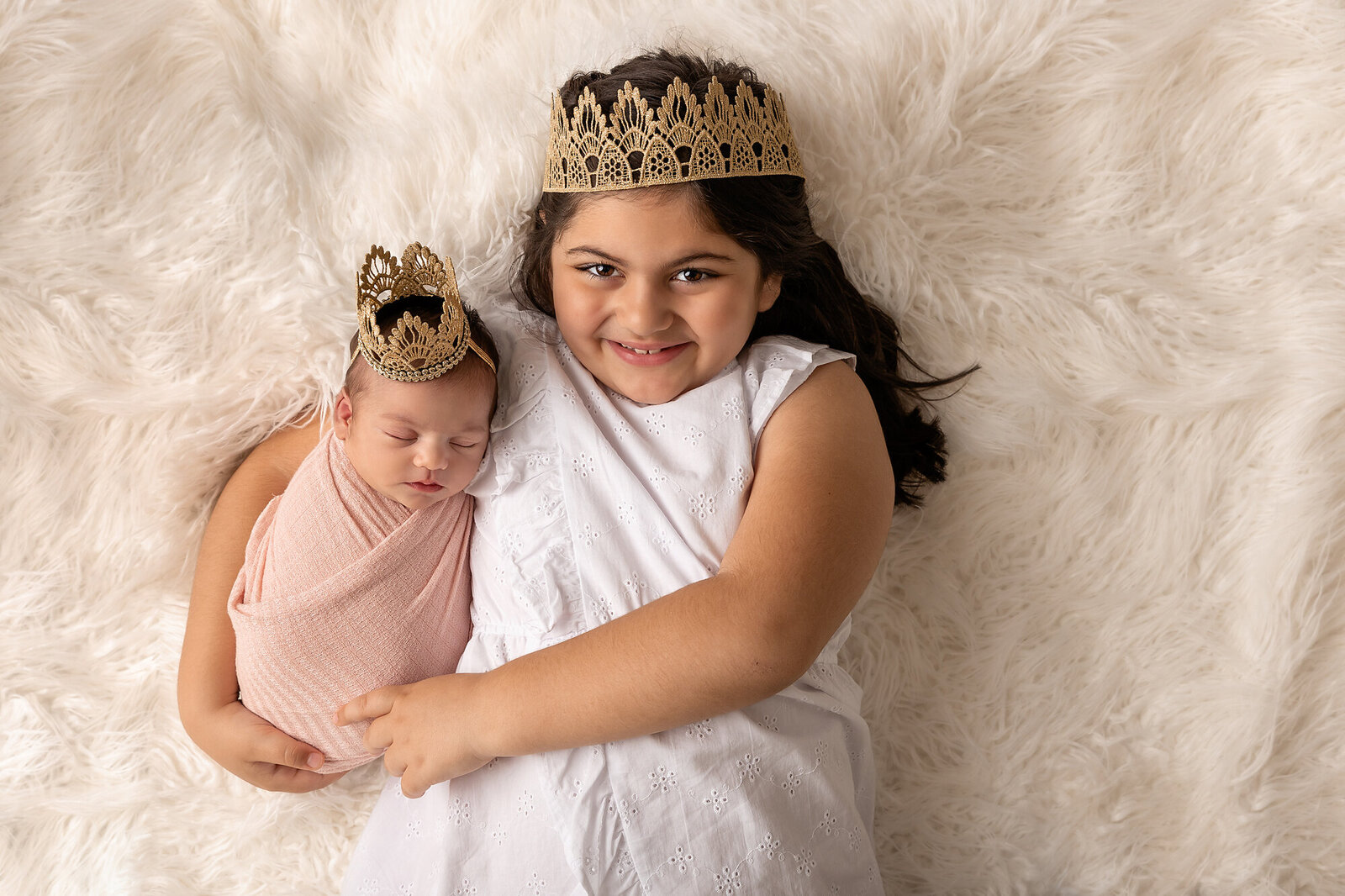baby and sister in crowns