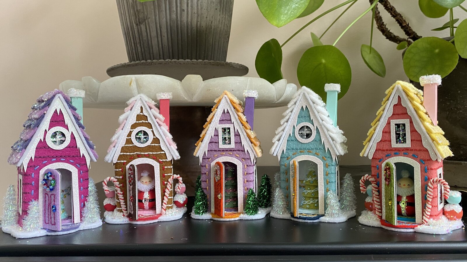 Handmade house ornaments out of felt, paper and glitter.