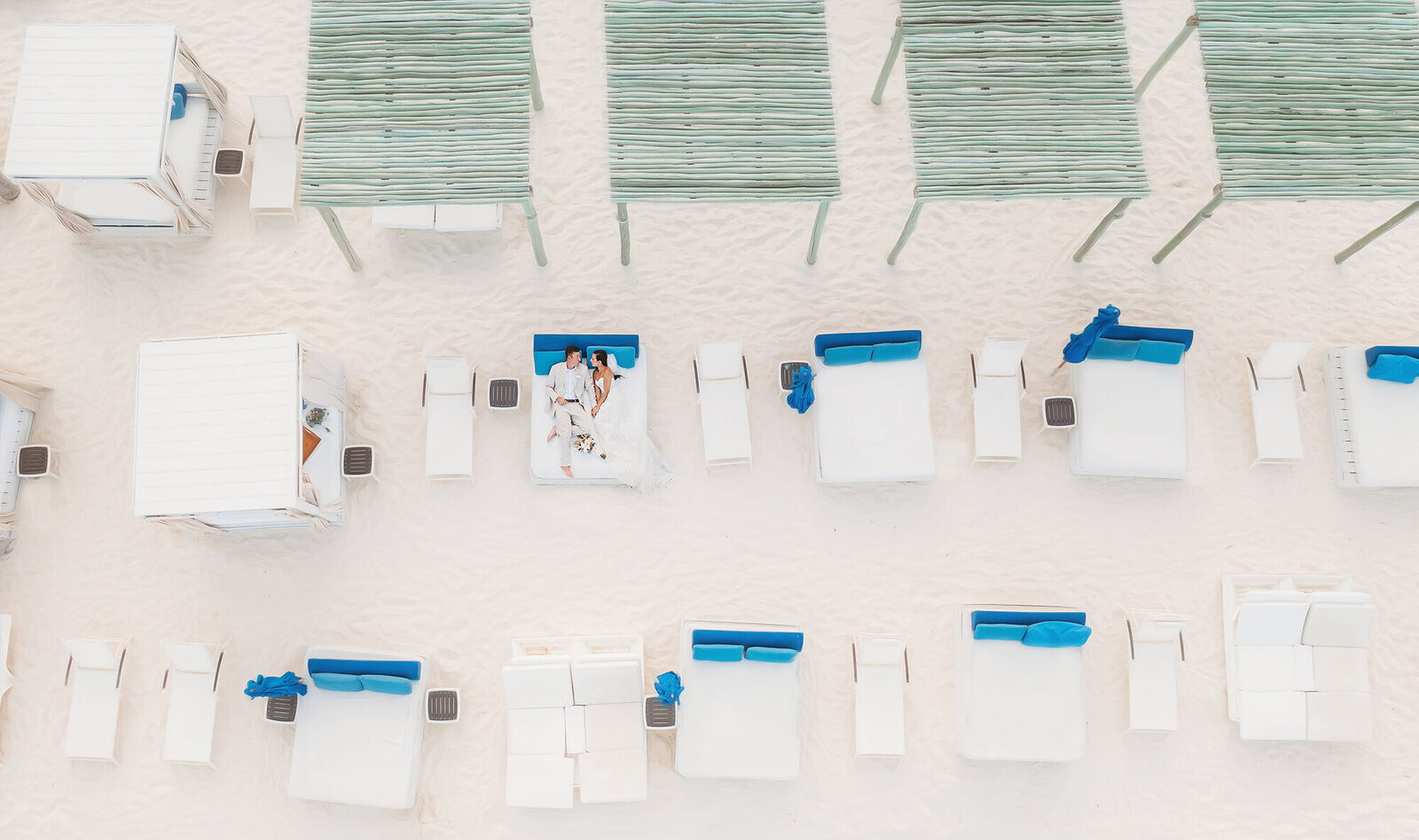 Couple snuggles on the beach on their Micro Wedding Day at Live Aqua resort in Cancun Mexico.