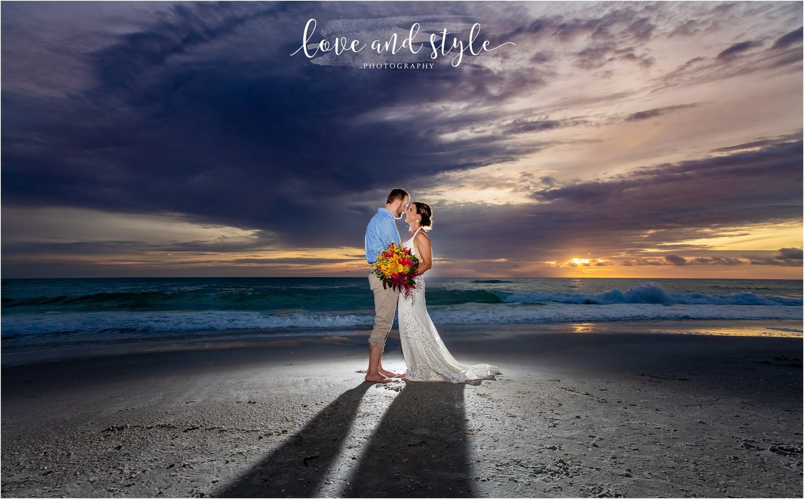 Bride and Groom backlit at Sunset on Holmes Beach in front of The Beach House Restaurant on Anna Maria Island