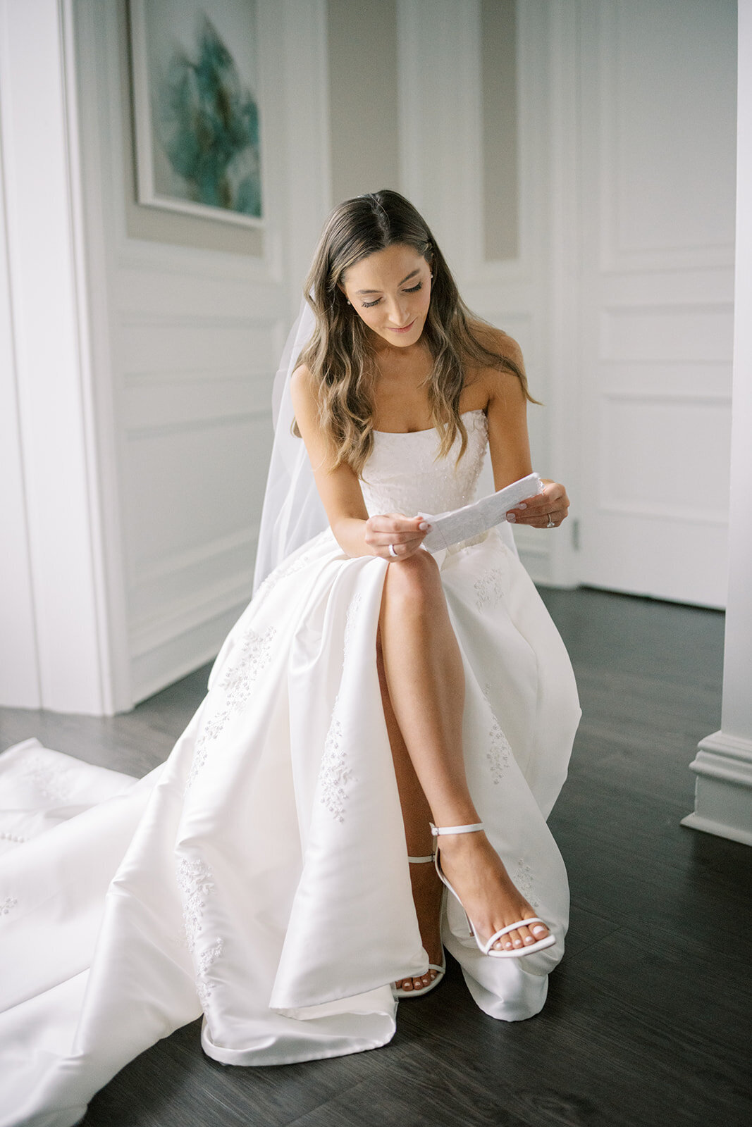 bride reading letter on wedding day